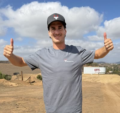 Jarryd McNeil giving a thumbs up in a Matador Fire shirt and hat